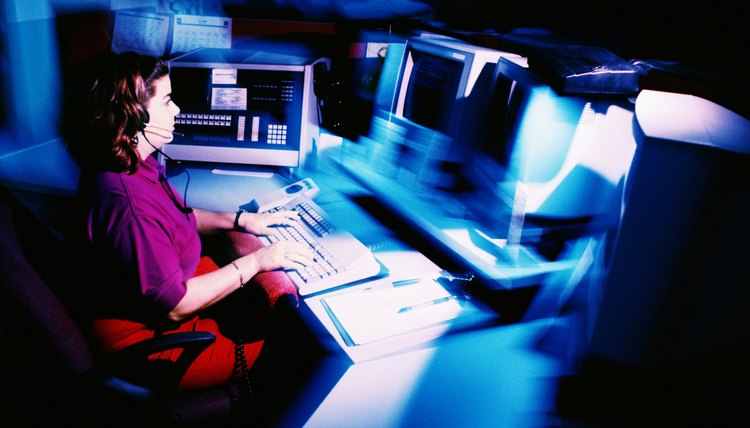 Woman working at police dispatch terminal