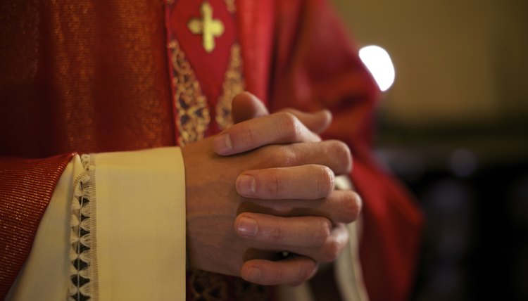 Catholic priest on altar praying during mass