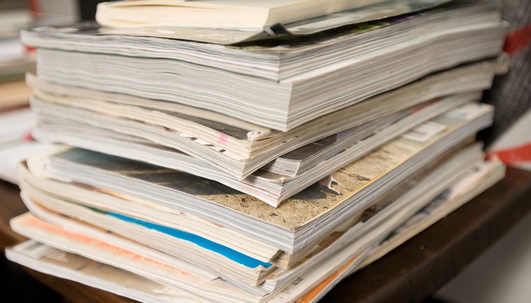 Stack of magazines and catalogs on desk