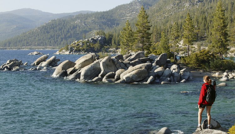 Woman hiking along the shore of Lake Tahoe