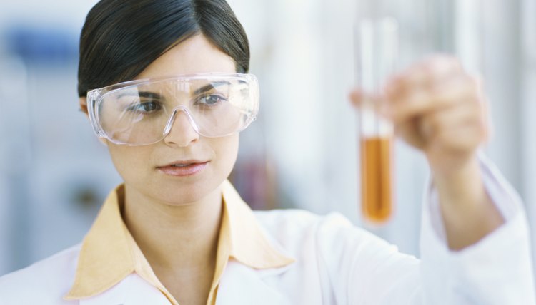 female scientist examining liquid in a test tube