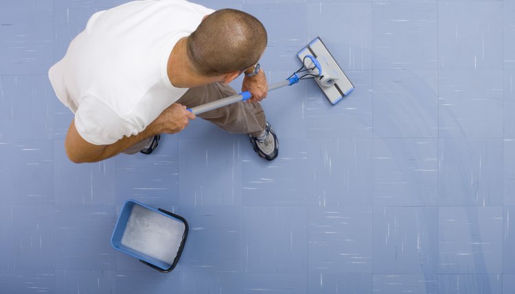 High angle view of man mopping floor