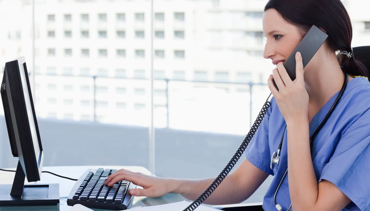 Female doctor on the phone while using a monitor