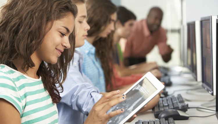 Girl Using Digital Tablet In Computer Class