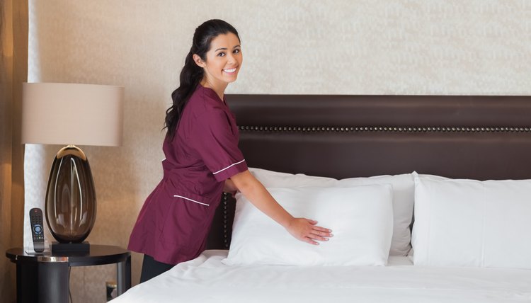 Happy hotel maid at work