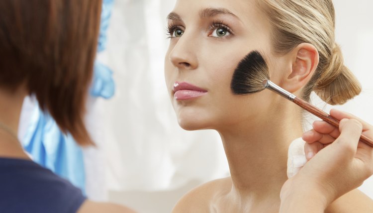 removing excess of powder using fan brush