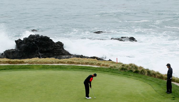 Phil Mickelson watches Tiger Woods putt on Pebble Beach's seventh green during the 2012 AT&T National Pro-Am.
