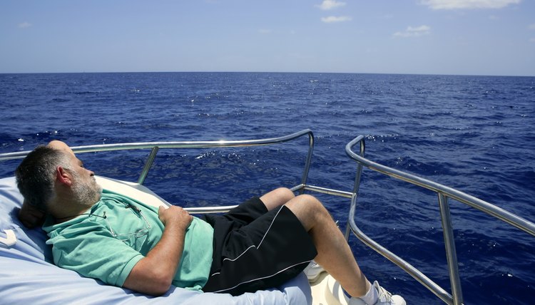 Sailor senior man having a rest on summer boat