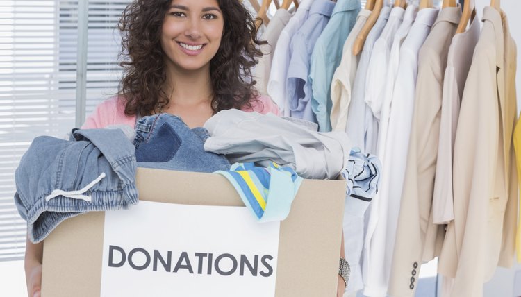 Volunteer holding clothes donation box