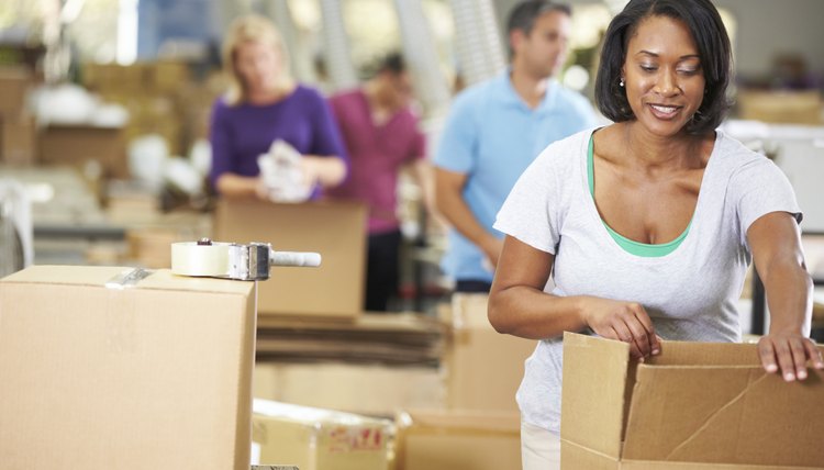 Workers In Warehouse Preparing Goods For Dispatch