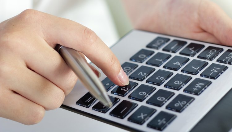 woman's hands with calculator and pen