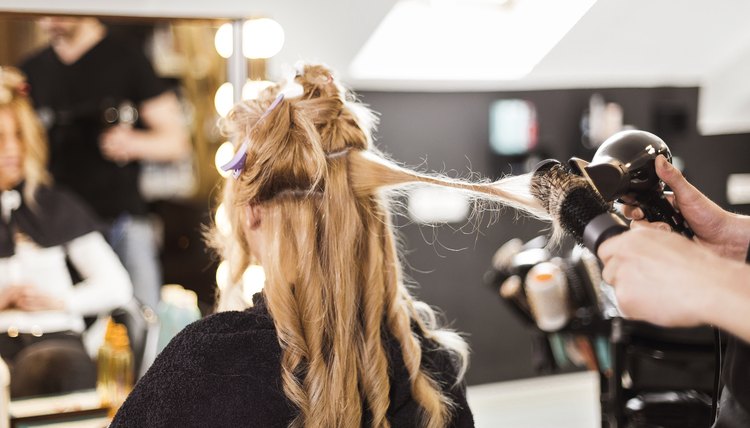 Hairdresser using hairdryer