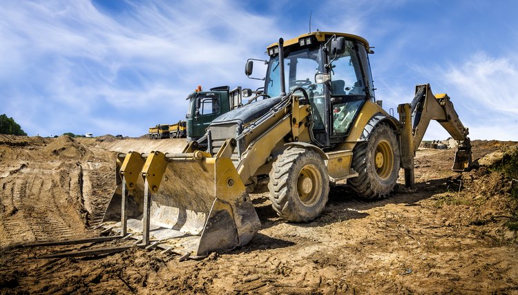 The yellow eart mover on the construction of highway, Poland