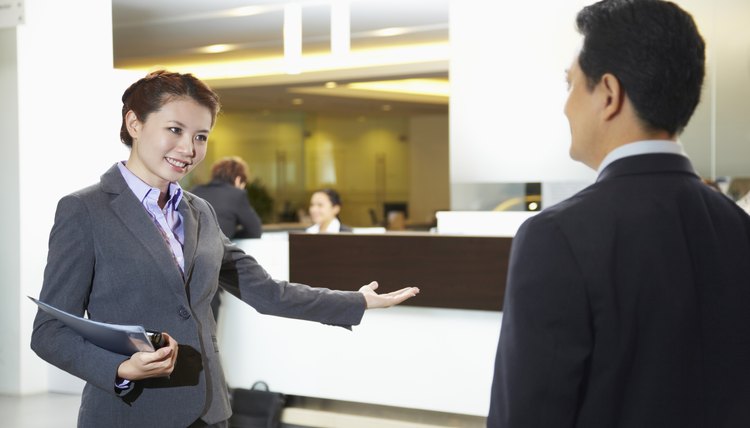 Sales representative ushering customer to the counter