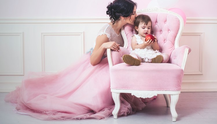 Mother and daughter a beautiful and happy pink interior with