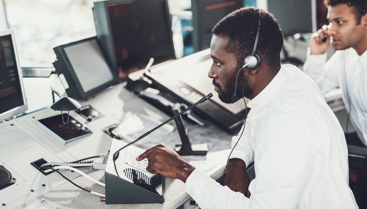 Dispatcher speaking by microphone on navigation board