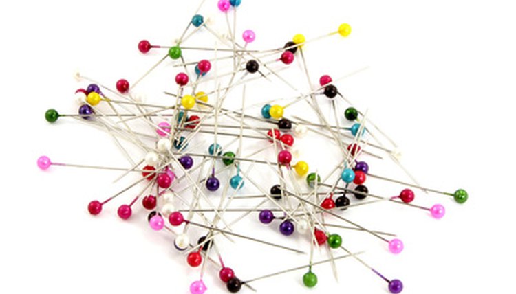 Dissecting pins have the rounded heads to make them easier to grasp while wearing gloves.