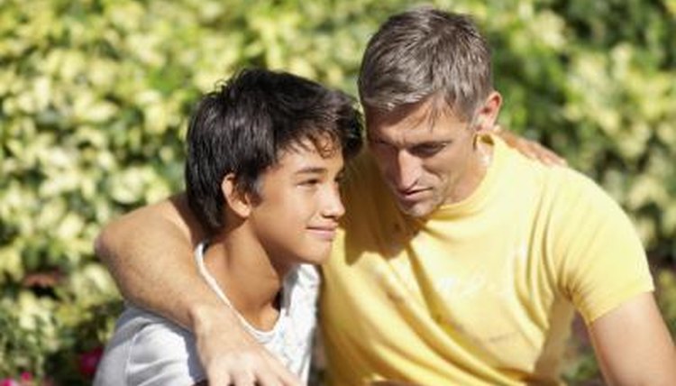Dad talking and hugging son