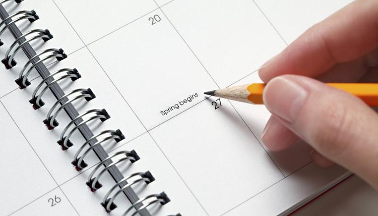Person writing in planner.