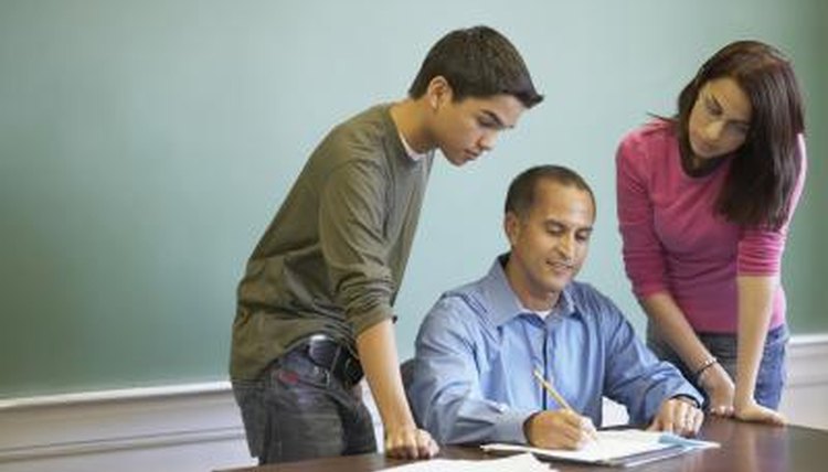 Teacher discussing results with two students