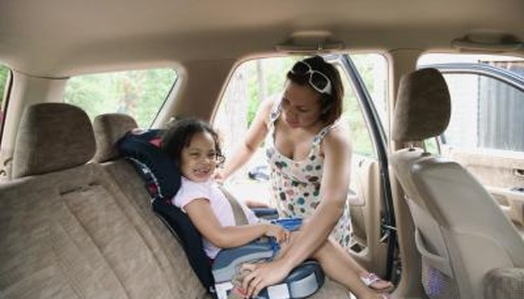 Mother putting chip in carseat