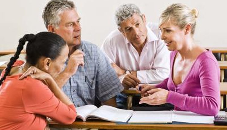 teacher interacting with adult students