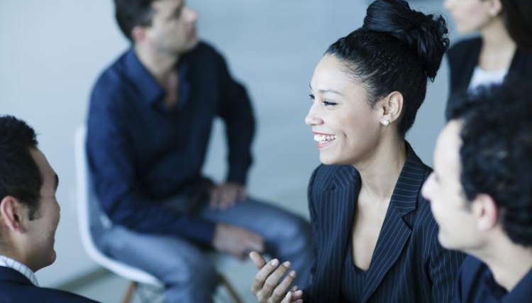 A group of young adults are discussing a common subject of interest