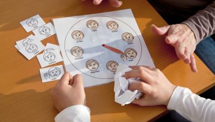 A teacher uses a chart to help a child work through emotions.