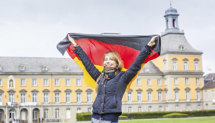 Girl with a German flag in front of Bonn University.