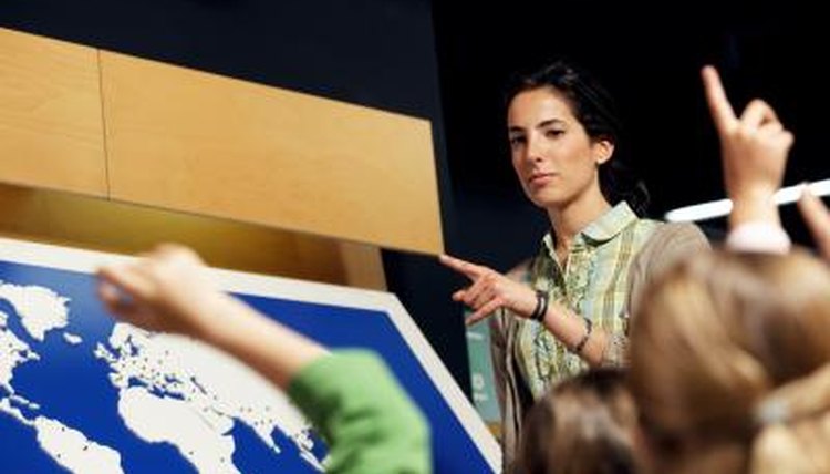 Teacher and students in geography classroom.