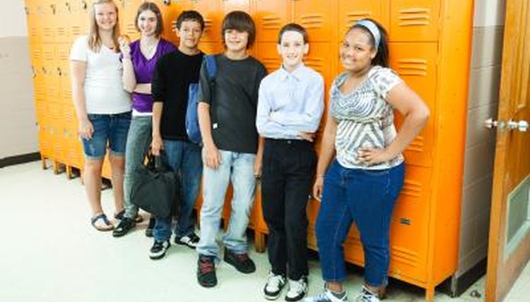 A group of high school students standing by lockers.
