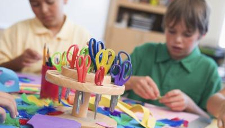 Kids in art class making paper bookmarks