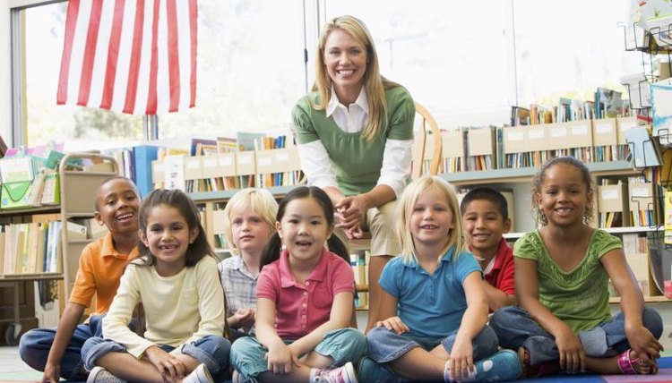 A kindergarten teacher with her class and an American flag.