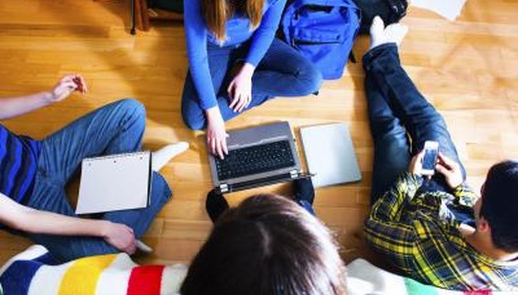 A group of students studying on the floor.