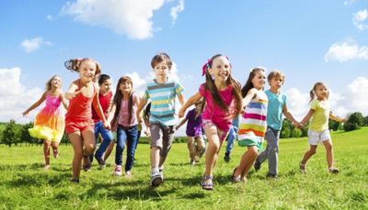 Class exploring on grass field