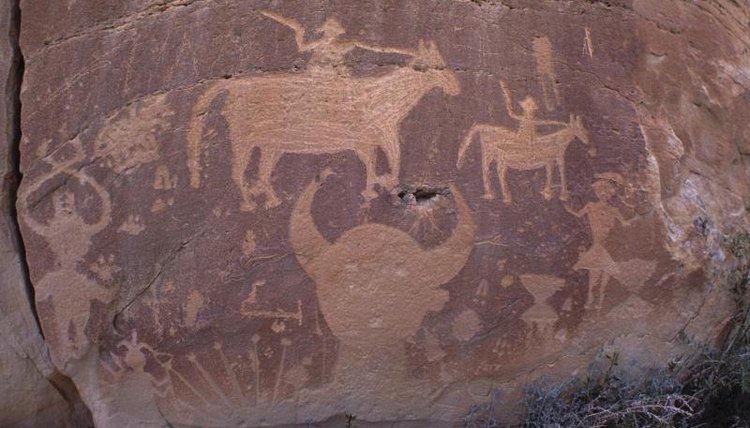 A close-up of cave paintings on a rock.