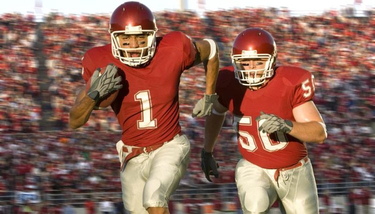 Football players running on the field