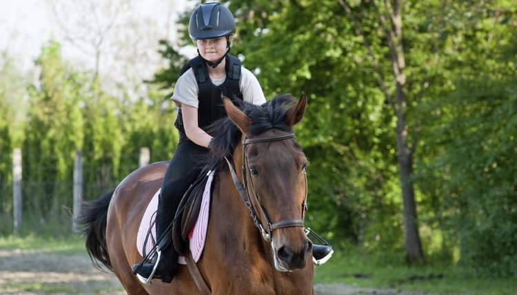 A girl is on horseback.