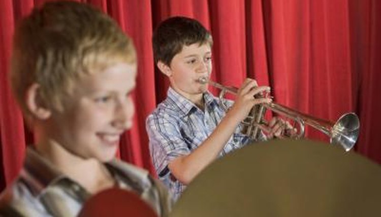 Boys playing instruments at a talent show.