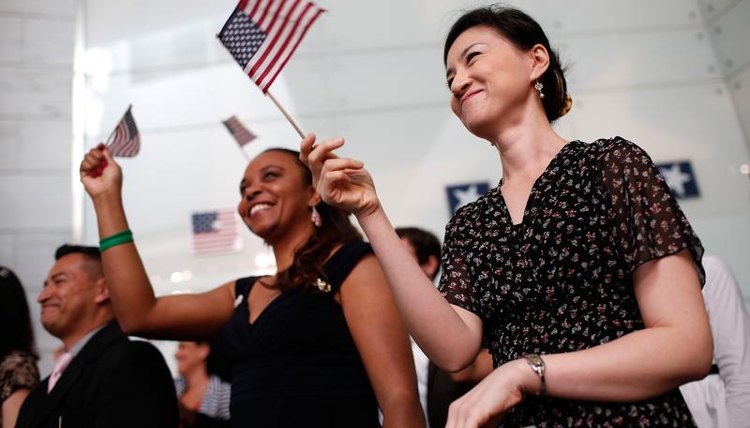 Patriots waving flags at a ceremony.
