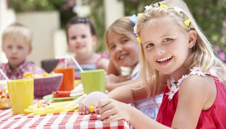 Children having an outdoor tea party.