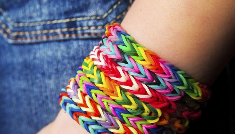 A girl wearing several friendship bracelets.