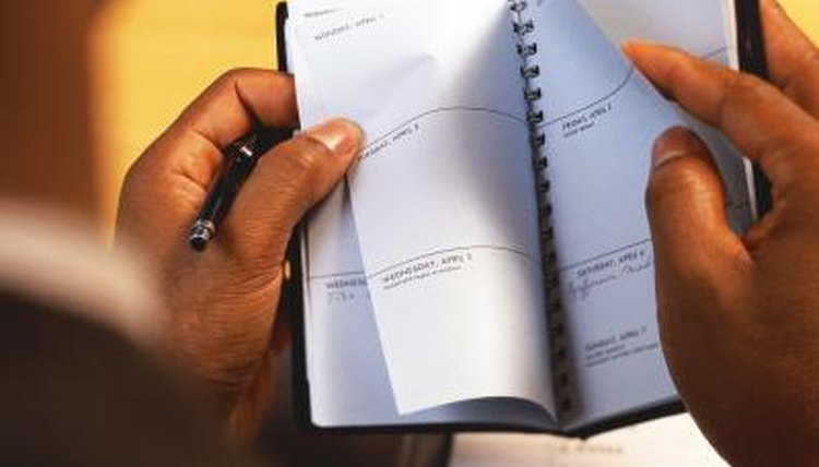 Man looking through planner.
