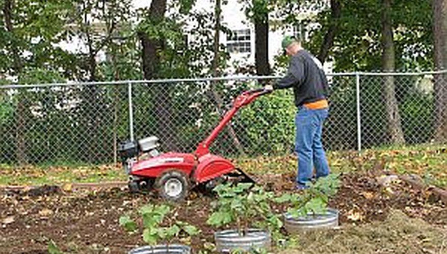 Rototill a garden bed to prepare the soil for planting Rototill a garden bed to prepare the soil for planting