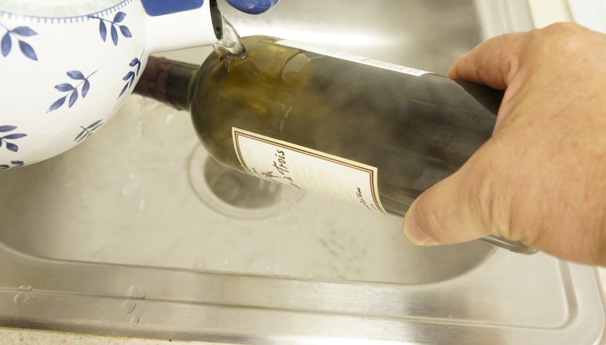 Photo Credit: Jeff Farris Heating the scored bottle.