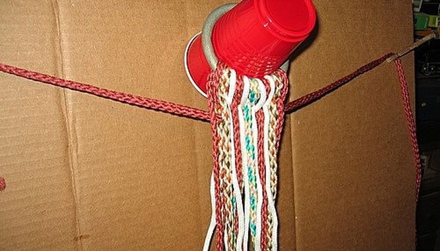 Far ropes are passed between front and back rows and draped over side nails