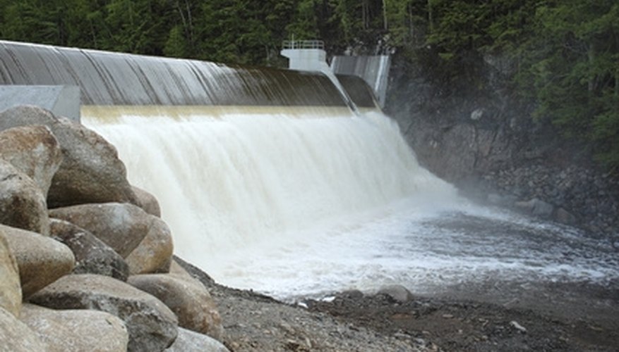 Water passes over and through a dam's spillway. Water passes over and through a dam's spillway.