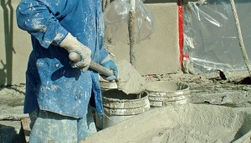 Mixing concrete in a wheelbarrow enables movement around the dam site. Mixing concrete in a wheelbarrow enables movement around the dam site.