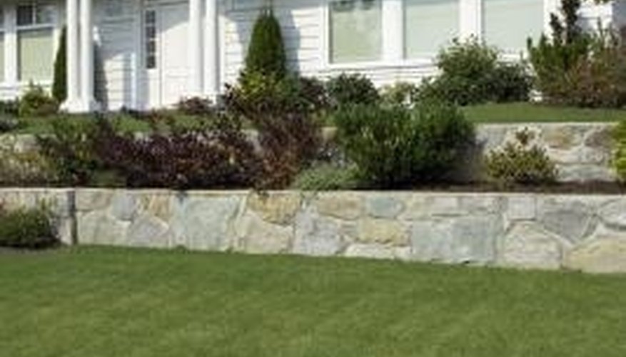 You can make a retaining wall out of wood or stone. You can make a retaining wall out of wood or stone.