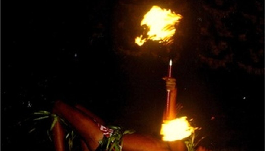 Samoan men perform dances with a fire knife. Samoan men perform dances with a fire knife.